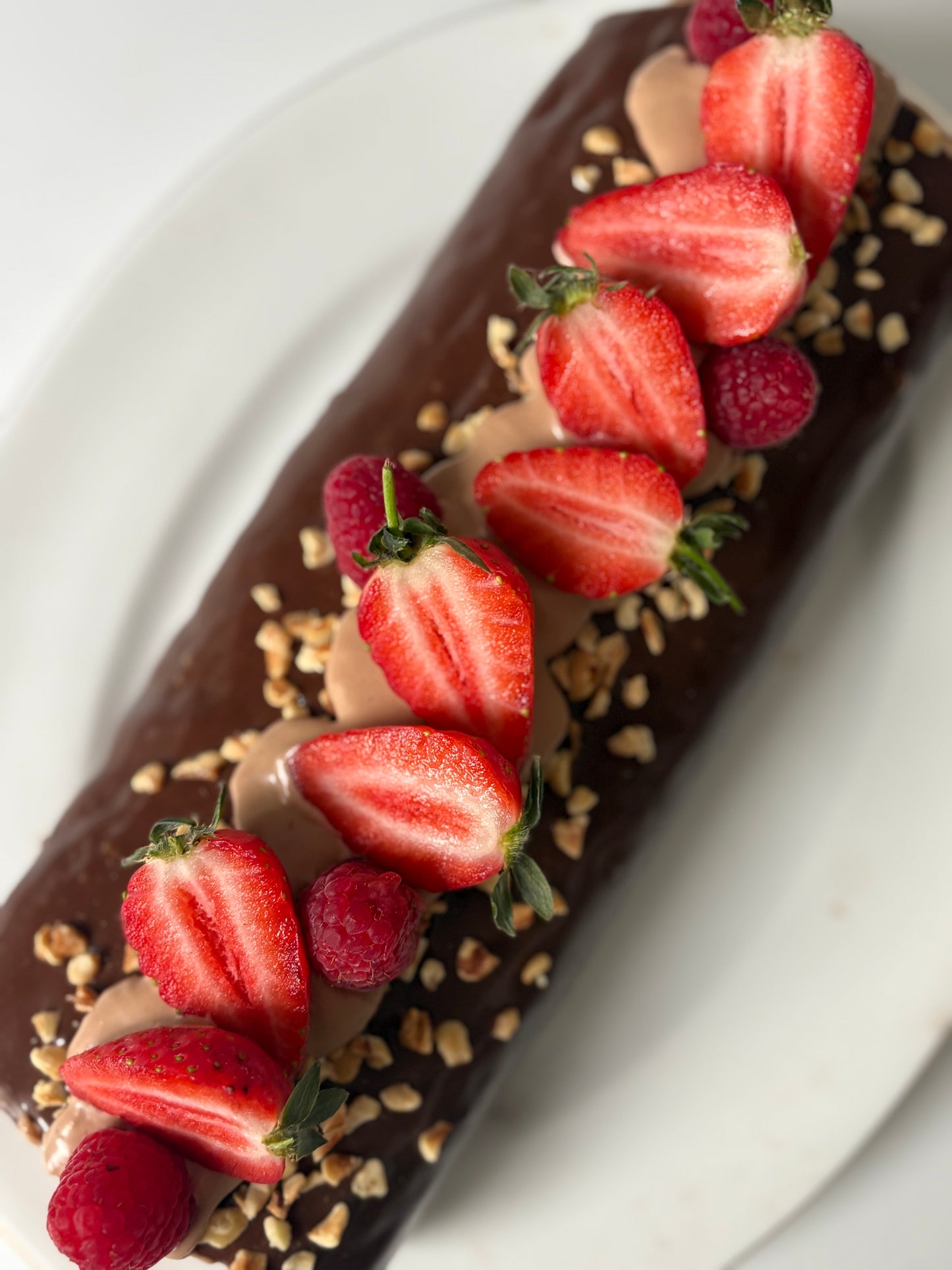 Chocolate swiss roll filled with strawberries and cream covered with milk chocolate ganache ❤️- pdf recipe