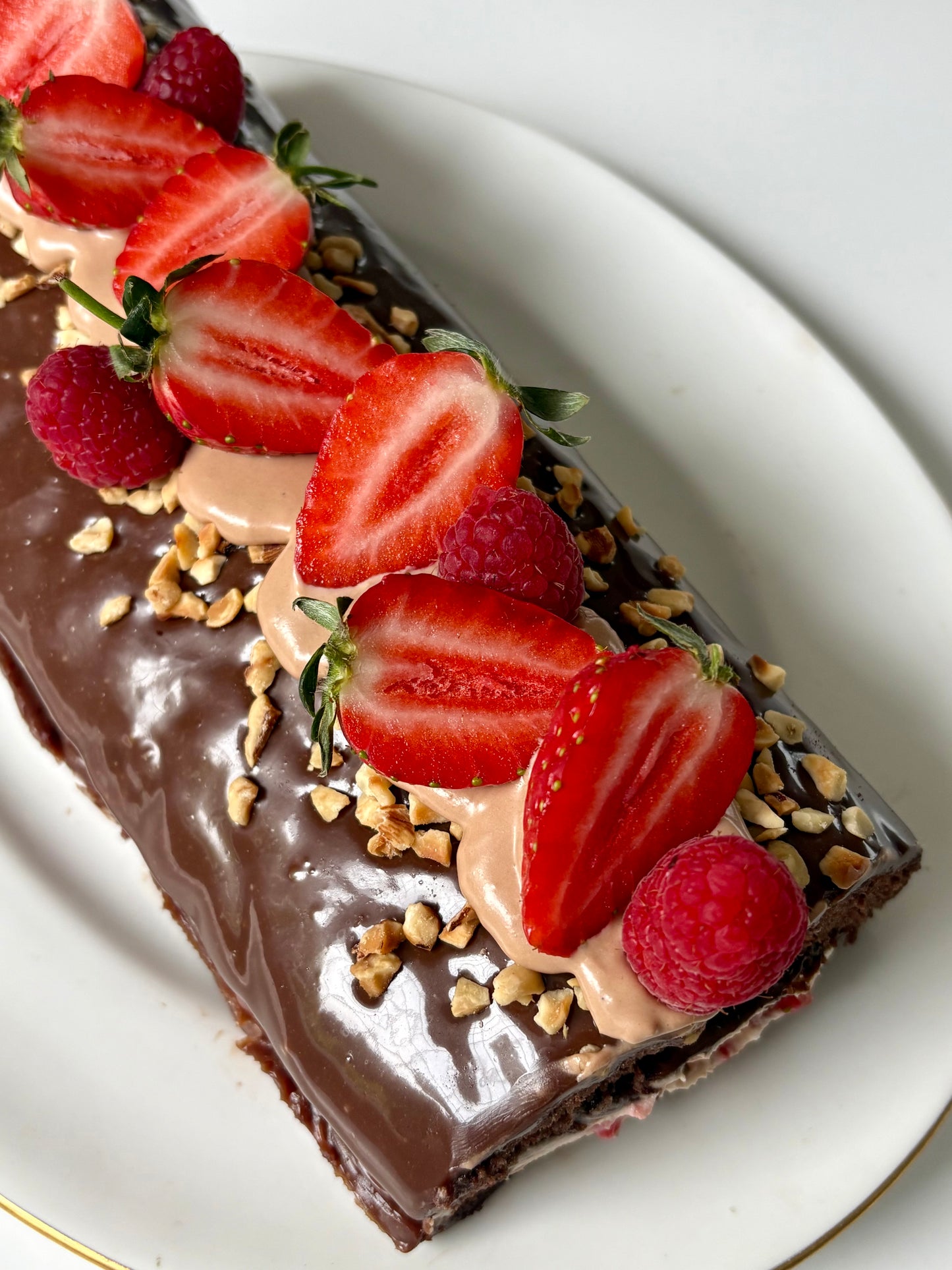 Chocolate swiss roll filled with strawberries and cream covered with milk chocolate ganache ❤️- pdf recipe